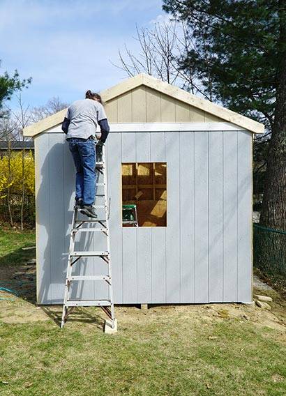 About Stellar Barn Co - image of builder working on shed in backyard